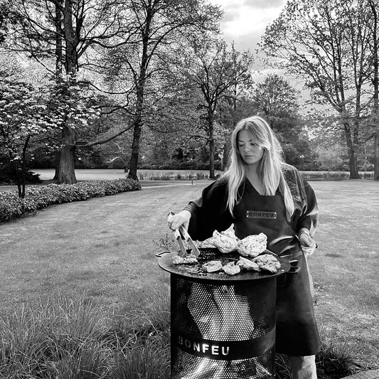 Person grilling outdoors in a Garden setting