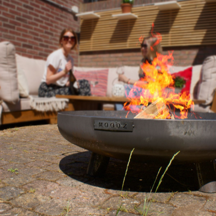 MOODZ grey stainless steel fire bowl on garden patio
