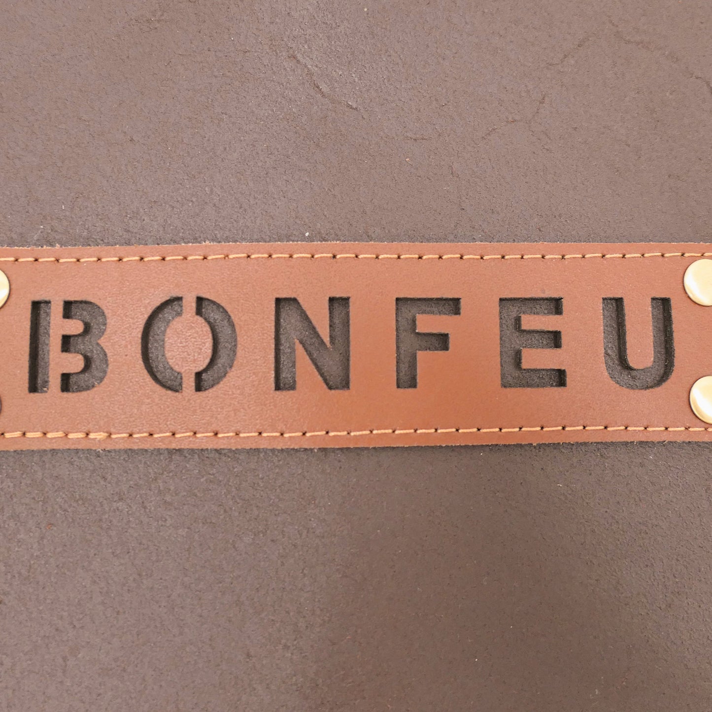 Brown leather patch with 'BONFEU' text on a brown background