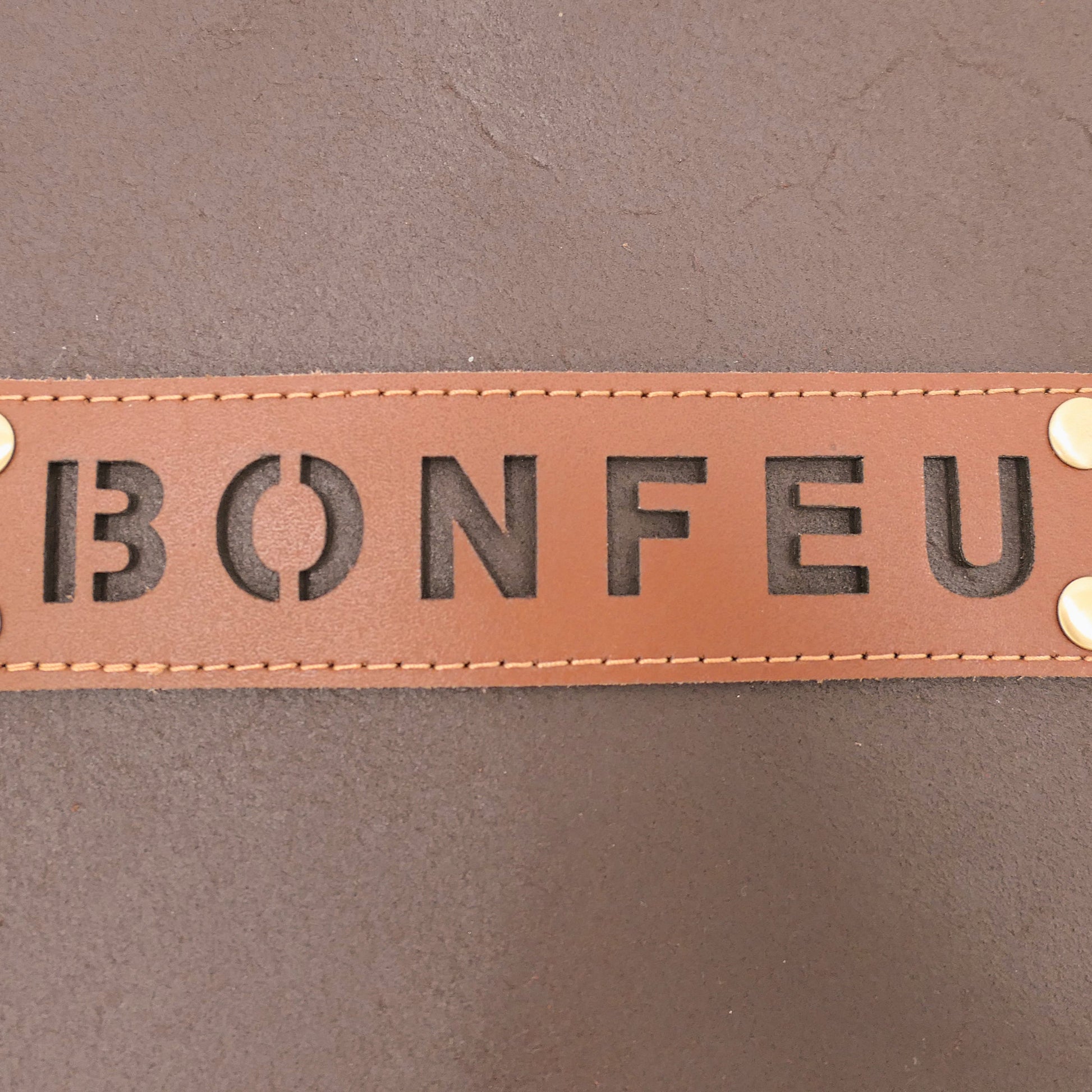 Brown leather patch with 'BONFEU' text on a brown background