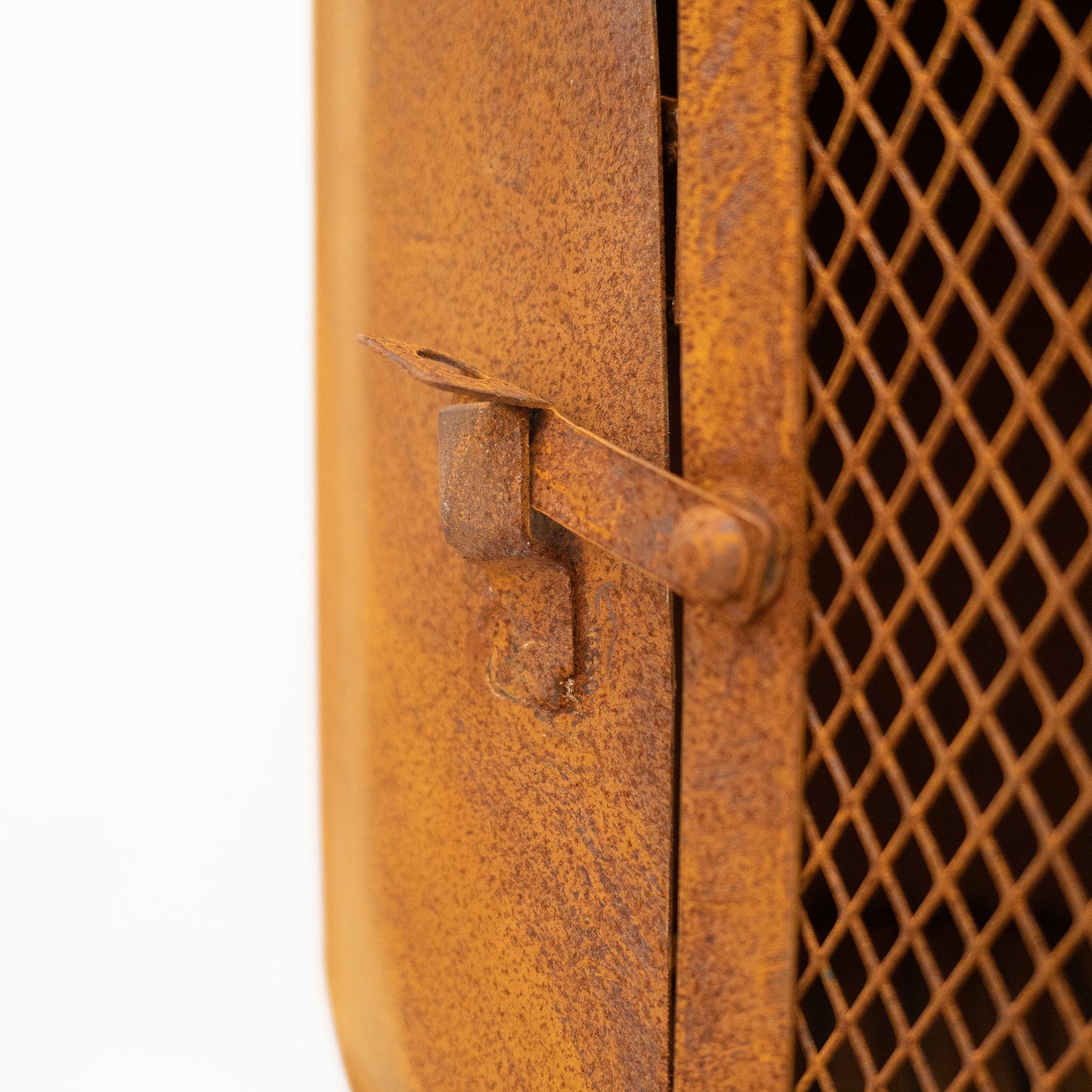 Rust-colored metal door with a grid pattern on a white background