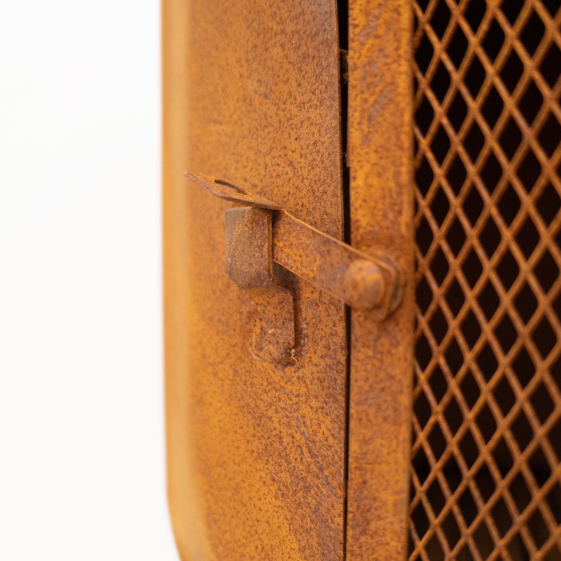 Rust-colored metal door with a grid pattern on a white background