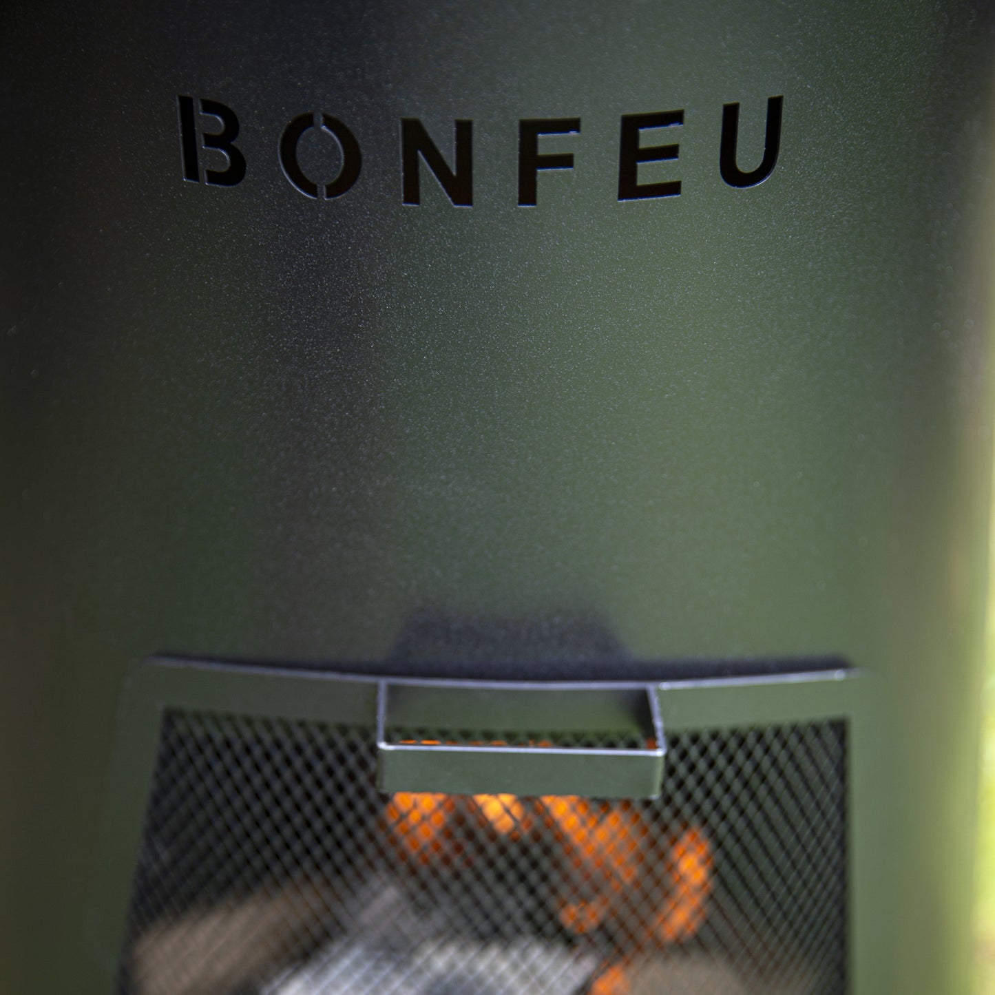 Bonfeu fire pit with flames and coals inside, brand name visible