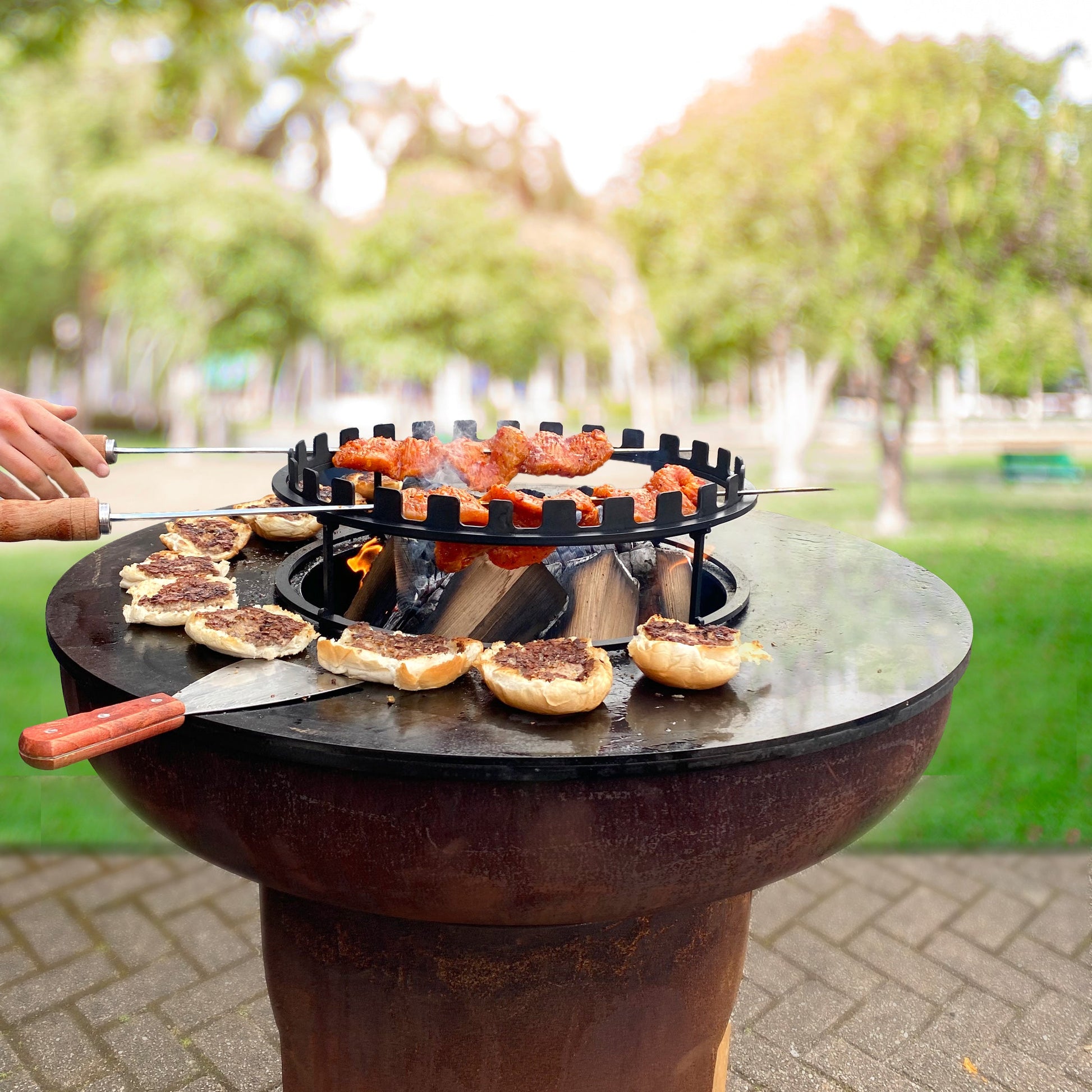 Outdoor cooking setup with a portable grill and food on a patio