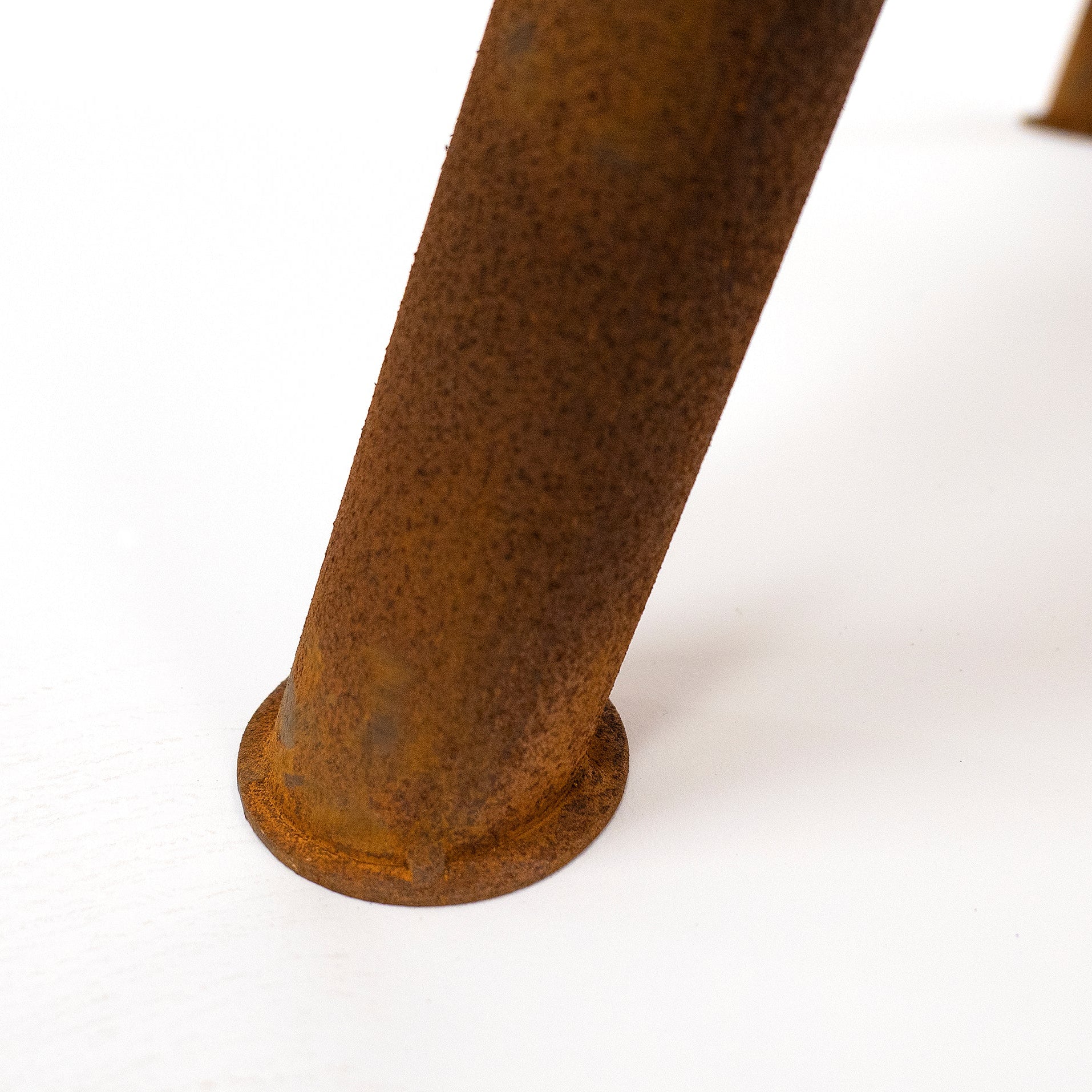 Close-up of a rusted metal pipe on a white background