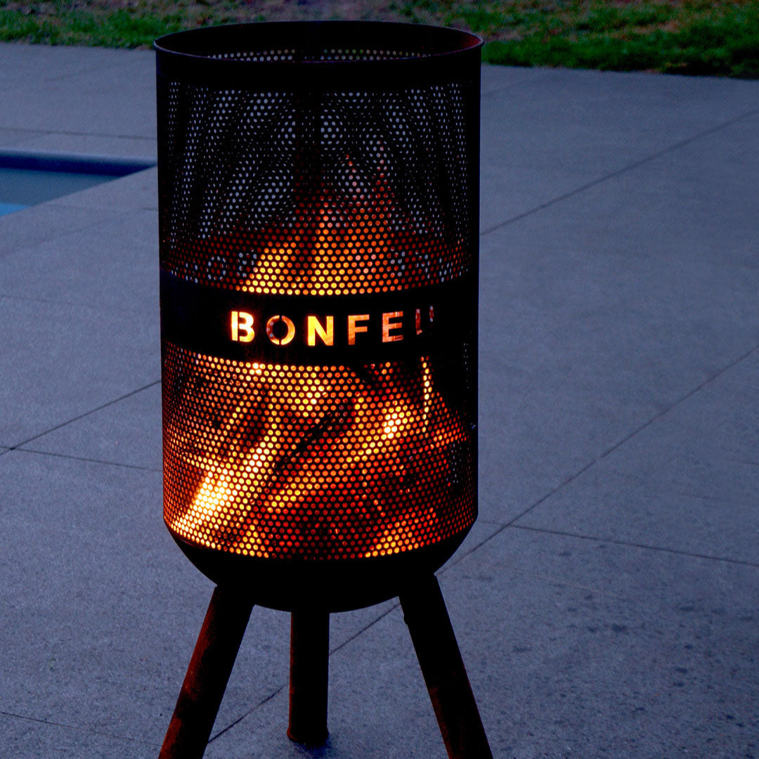 Bonfire-style lamp with glowing interior on a dark background