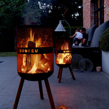 Bonfeu fire pits on a patio with people sitting nearby