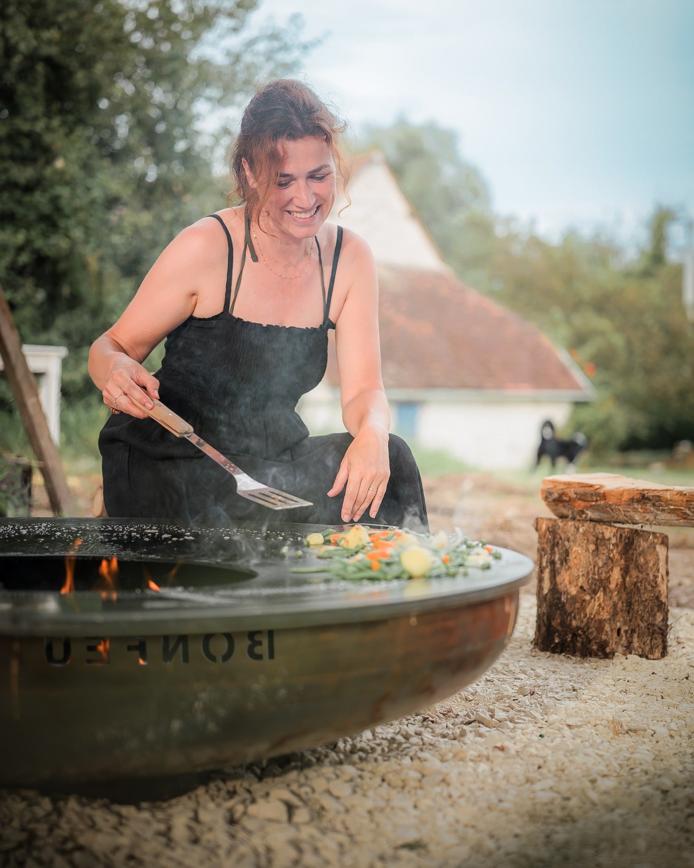 Premium UK garden with outdoor kitchen, BBQ, and plancha showing stylish outdoor living