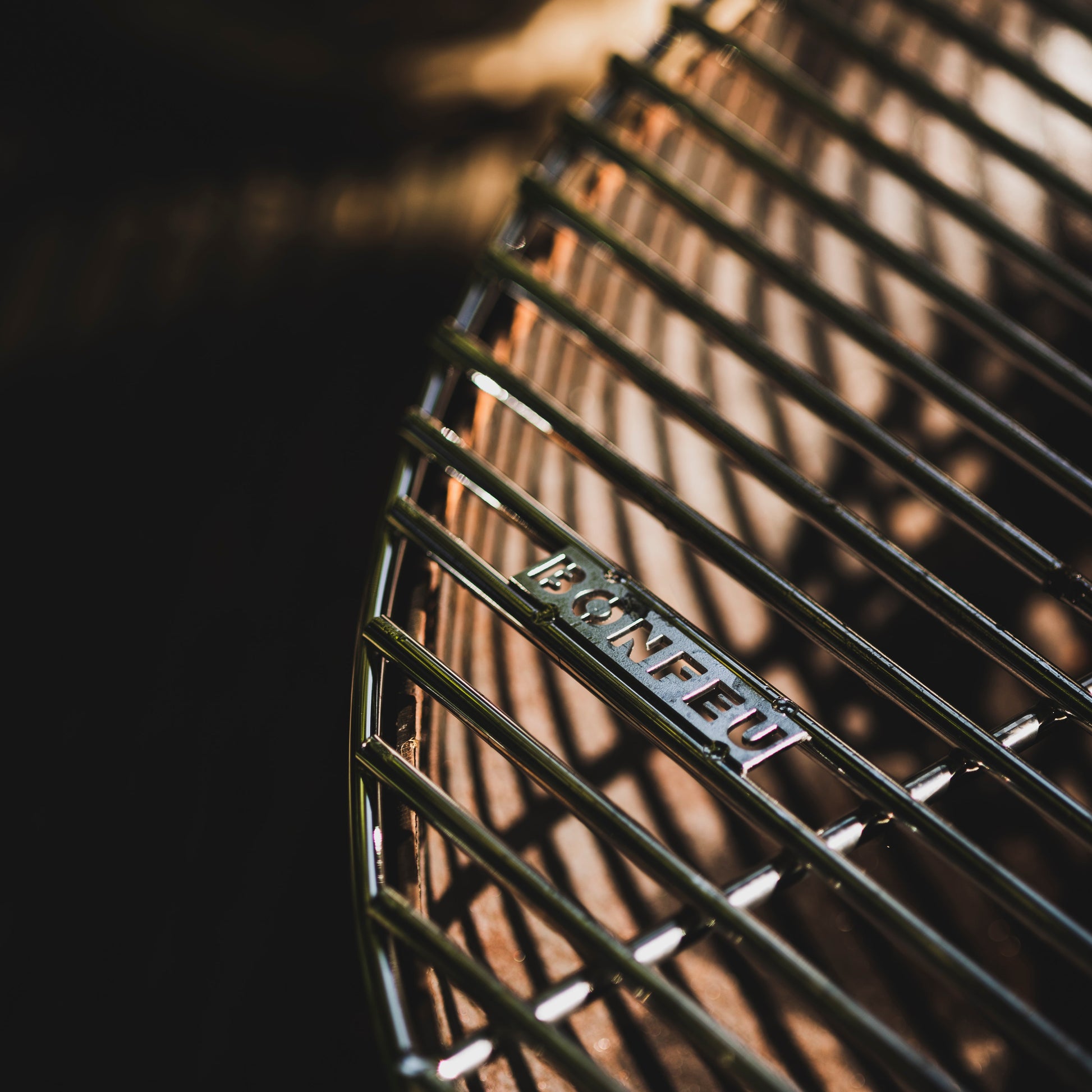 Close-up of a grill with  branding, blurred background
