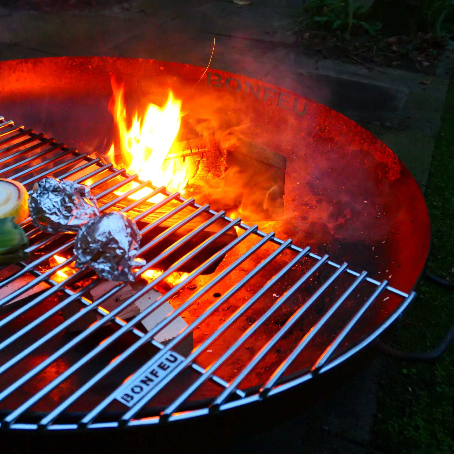 Grill with food being cooked over an open flame