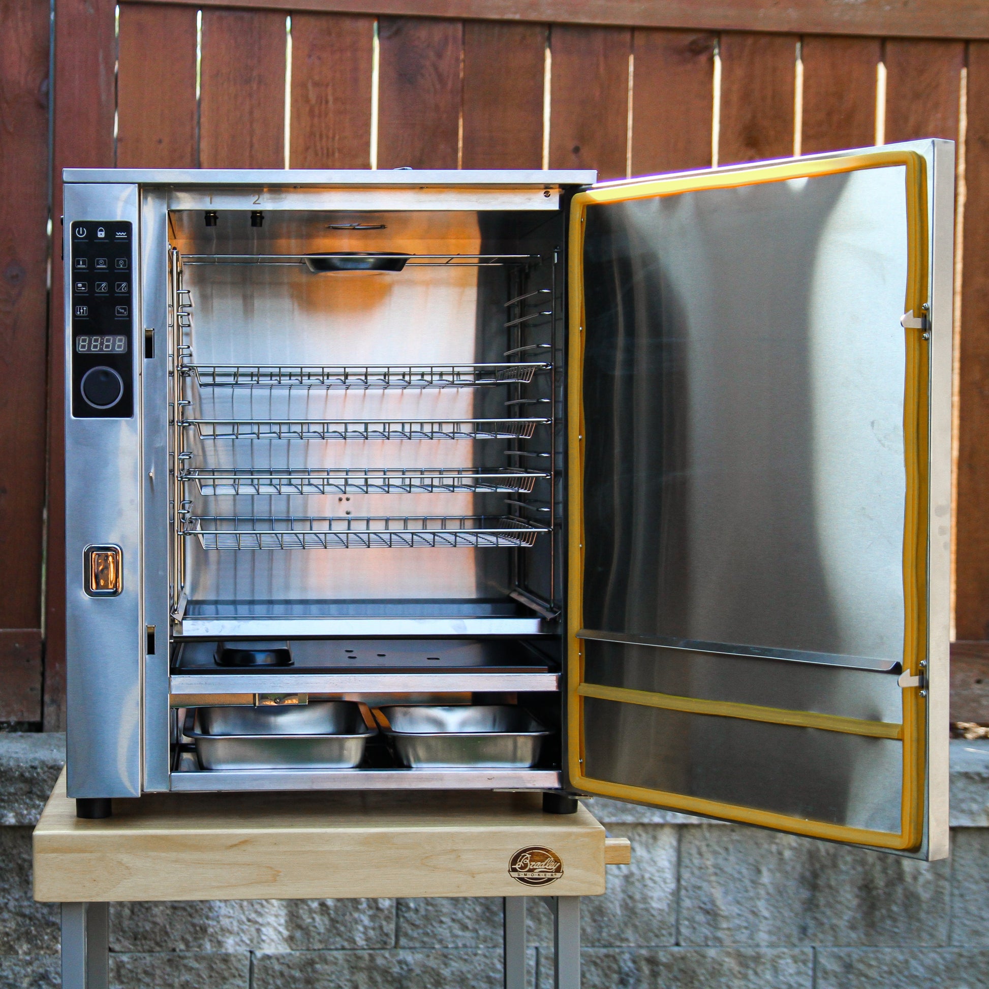 Commercial oven with open door on a wooden background