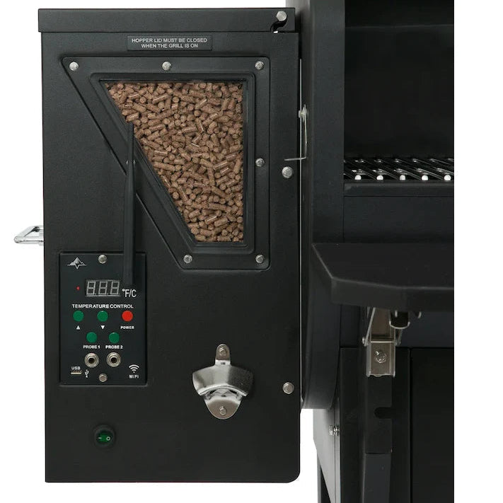 Pellet smoker with control panel and wood pellets inside, on a white background